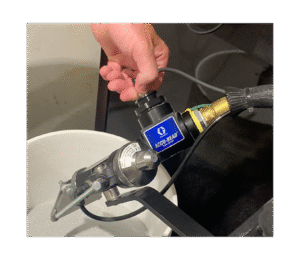 Photo of an ACCU-BEAD flow sensor being installed on a road striping bead gun